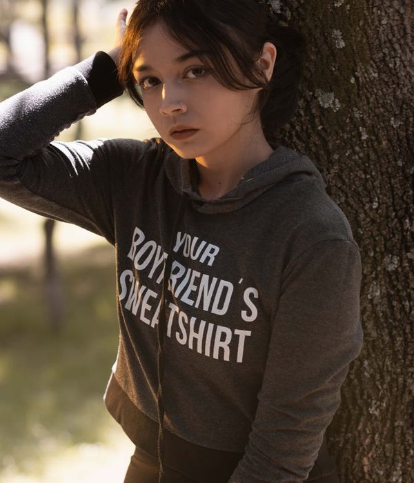 Person breathing deeply in a beautiful forest setting at sunrise.